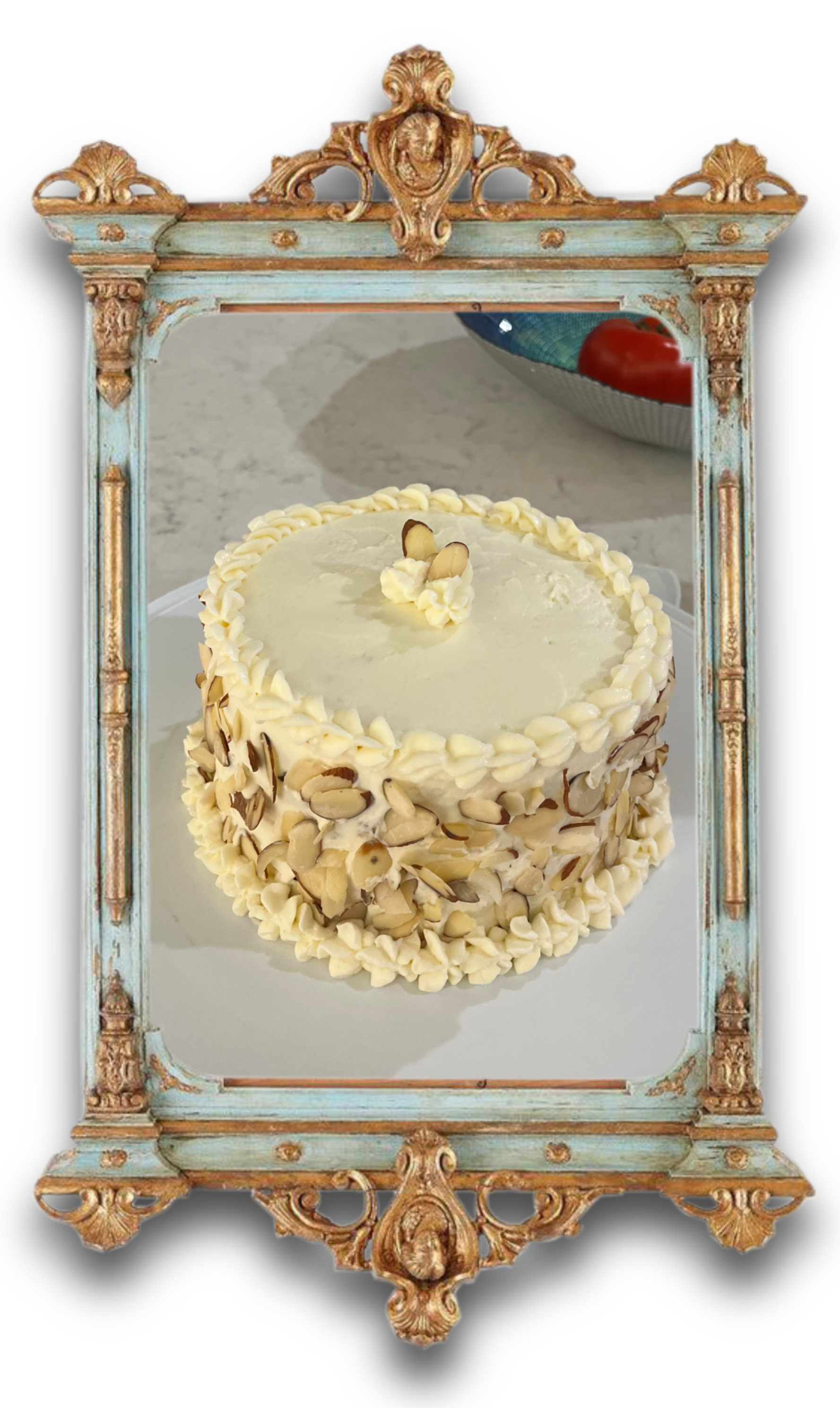 A white cake decorated with almond slices.